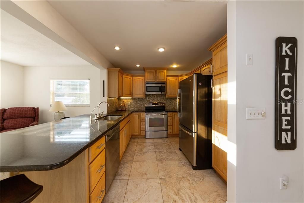 Large kitchen with breakfast bar that opens to bonus room