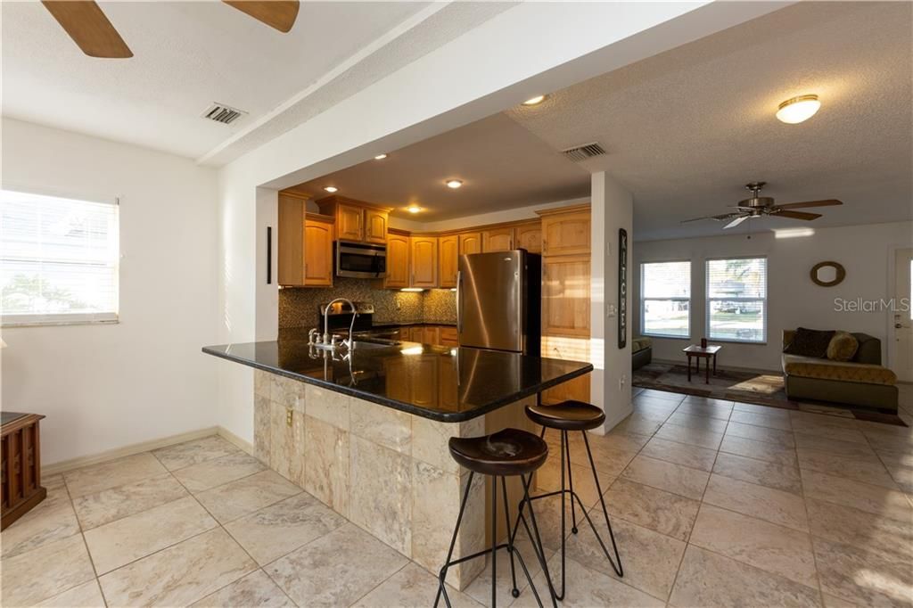 updated kitchen with wrap around breakfast bar seating