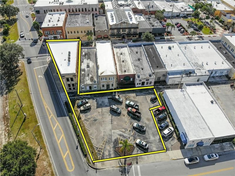 Aerial view of the unique design of the building and the 22 space parking lot directly behind the building.  The pictures were taken prior to the parking lot being recoated and striped.
