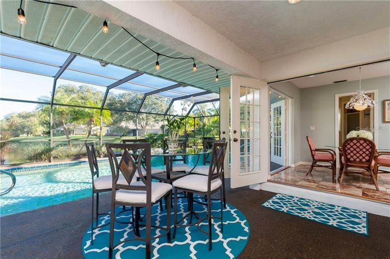 Dining from deck or kitchen overlooking pool and pond.