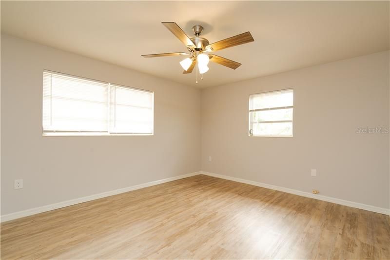 Spacious master bedroom with ceiling fan