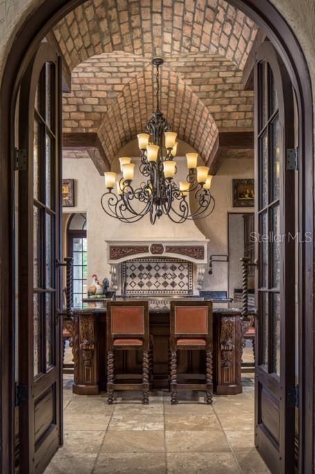 Continuing to the kitchen, French doors with bevelled glass open to reveal Chicago brick arched to form a spectacular groin ceiling and chef inspired appliances.