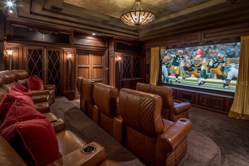 Rounding out the second floor spaces is the home theater with seating for twelve, an iPad controlled projector, a kitchenette with two beverage drawers, two dishwashers and a built-in candy display.