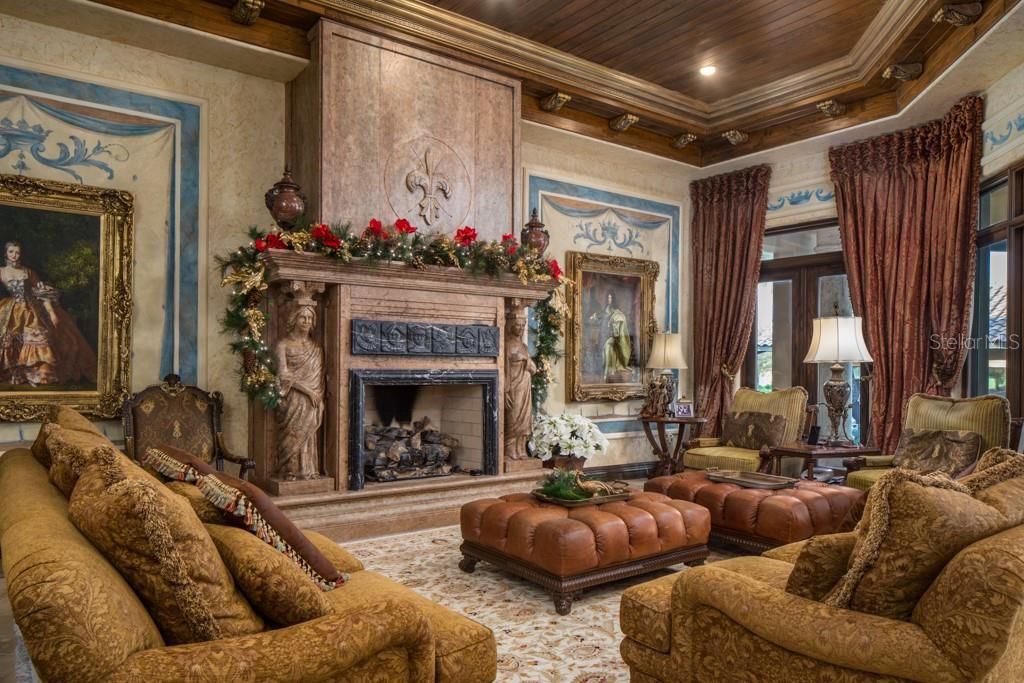 The great room offers several sitting areas for entertaining and features a gas fireplace made of honed marble.