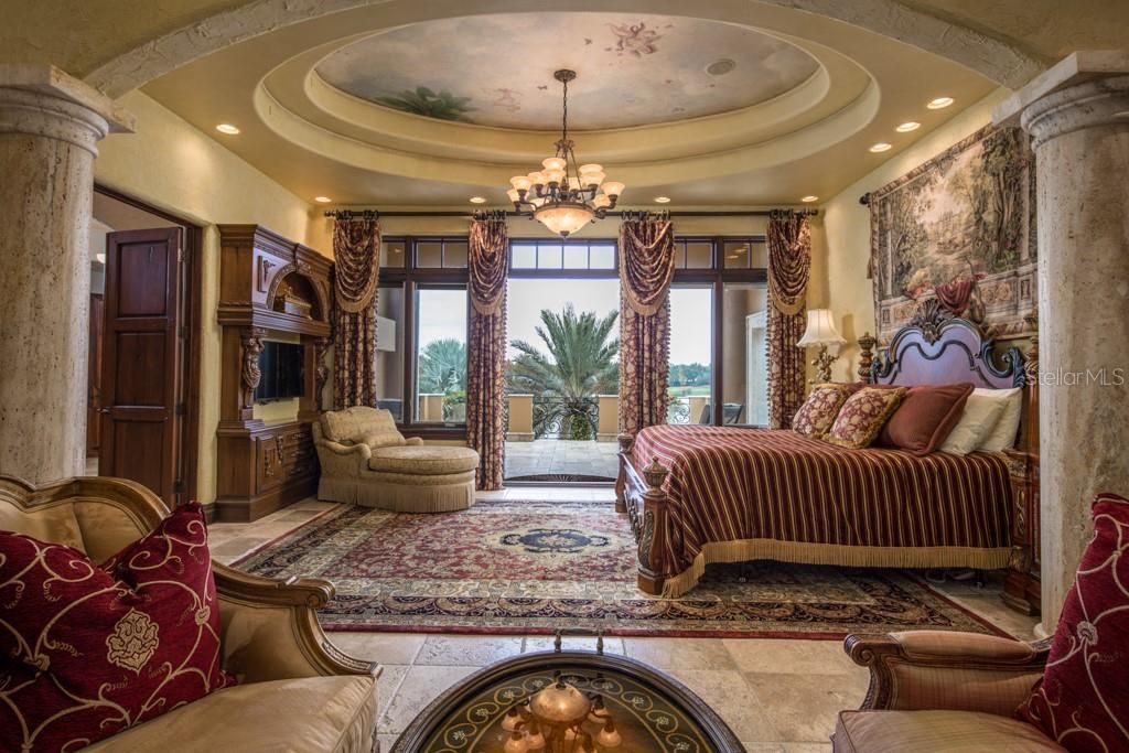 The estate features two master suites. The main spacious suite opens to a grand balcony and endless views of Hourglass Lake. A custom tray ceiling with hand-painted mural is awe inspiring amongst the stone columns.