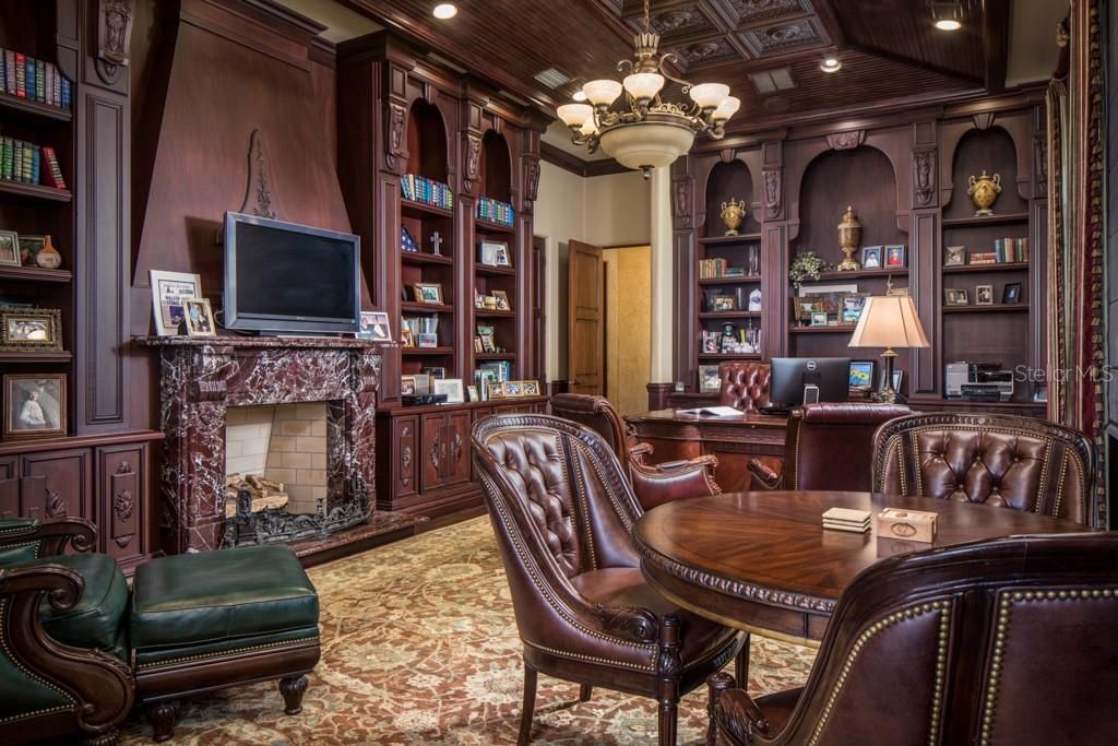 The formal office with gas fireplace and custom built-ins is situated on the west wing of the estate and offers a secret stairway leading to the secondary master suite on the second floor.