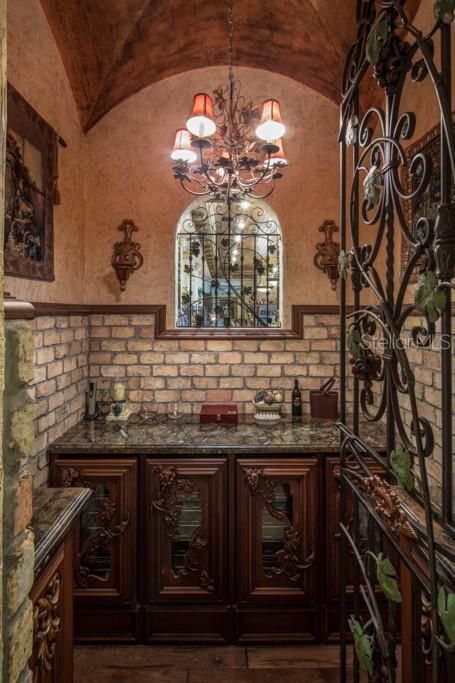 The step-down wine cellar features a groil ceiling and six coolers for up to 280 bottles of wine.