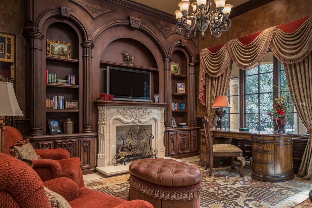 Via the elevator, you arrive at the second floor east wing sitting room with gas fireplace, hand carved bookshelves and balcony.