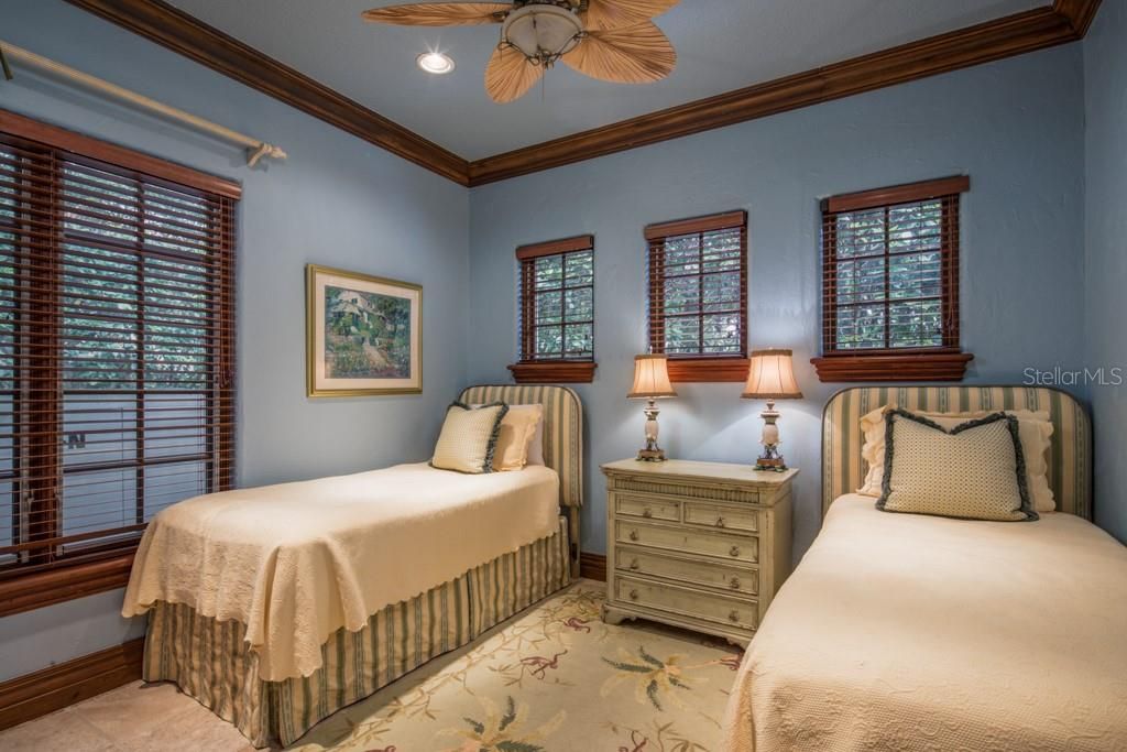 The spacious private bedroom within the guest house comfortably fits two guest beds.