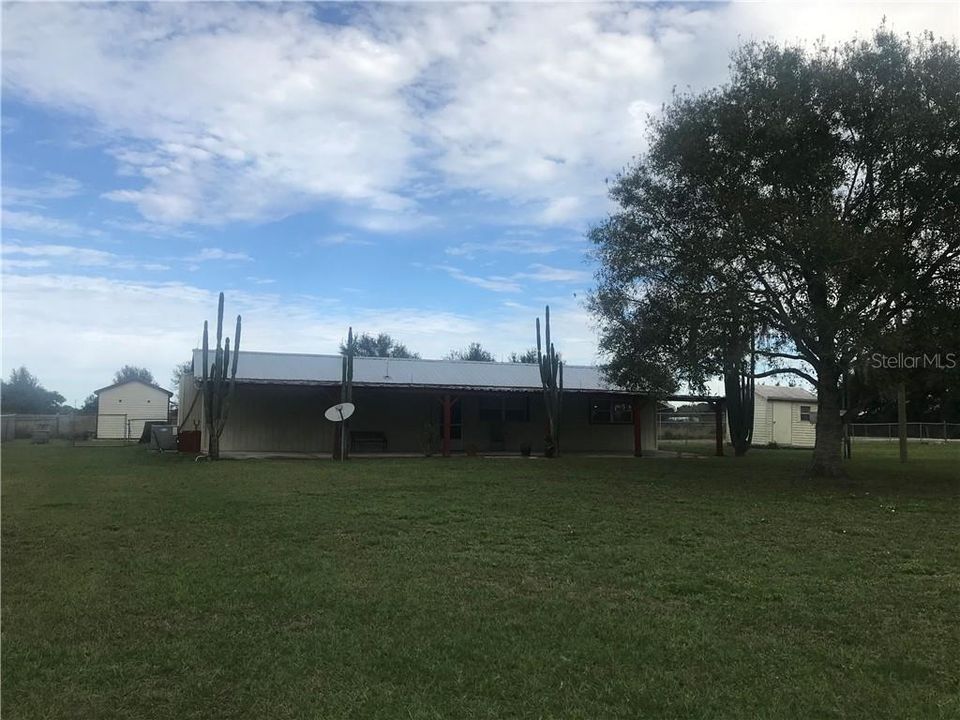 Home has a large covered porch and 2 sheds.