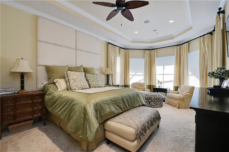 Master Bedroom where the magic happens! Tray ceilings pool door access and tri windows views.