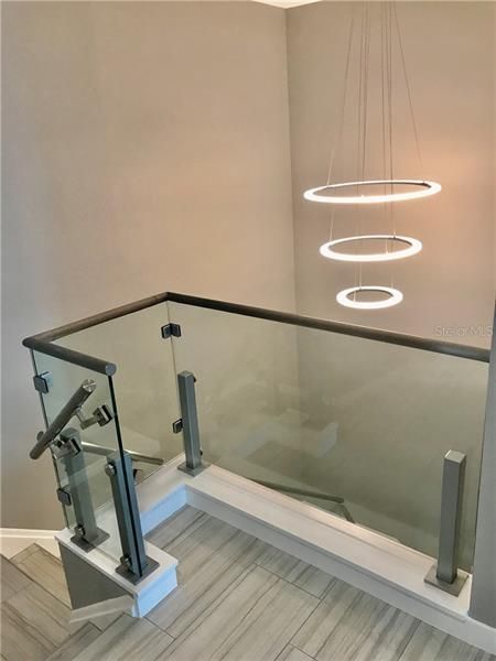 Upstairs stair landing with modern lighting in staircase