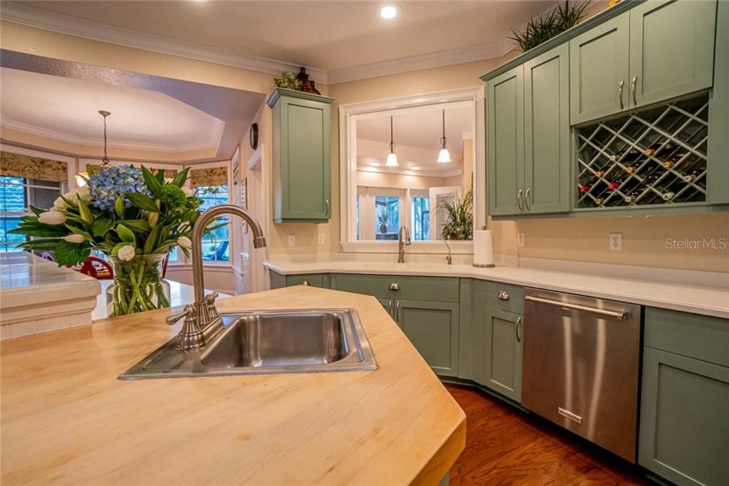 Butcher block island with 2nd sink, built in wine storage.