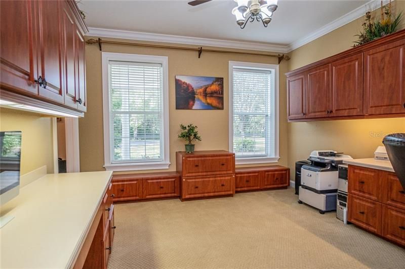 Office in front of house off Foyer, built in desks and cabinets for two work stations.