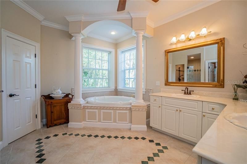 Master Bathroom with jetted tub, walk in shower and dual vanities.