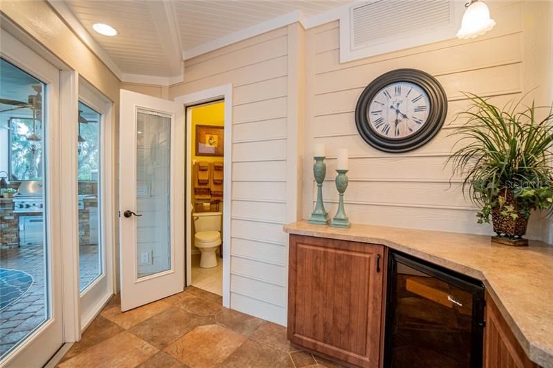 Back Foyer off Kitchen and Breakfast Nook with full Pool bathroom and beverage center / wine refrigerator.