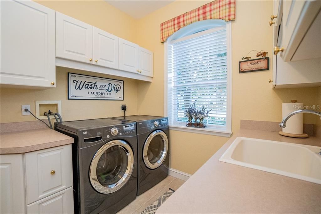 Laundry room downstairs between Kitchen desk niche and garage.