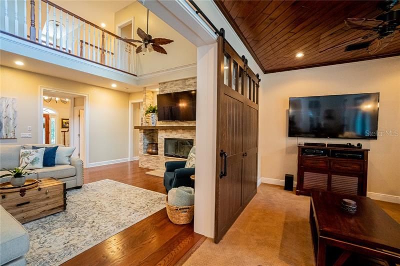 Barn door closes to give Living Room privacy from Family Room. Built in bookcases behind Barn Door.