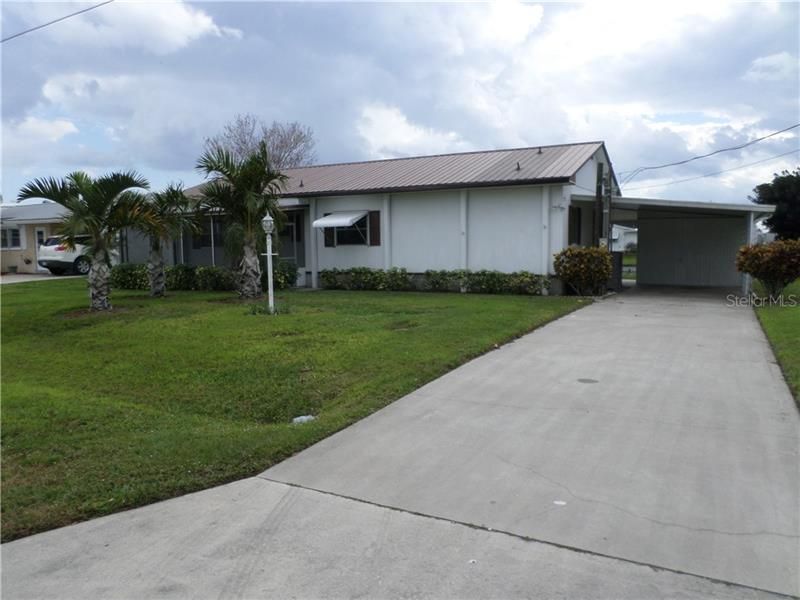 FRONT WITH CARPORT & FRONT SCREENED PORCH