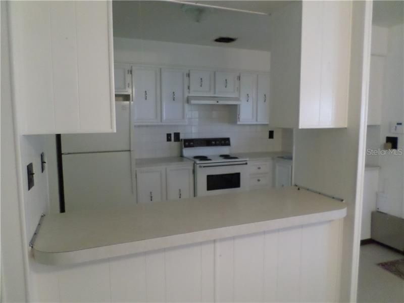 BAR OF KITCHEN OPENS TO LIVING ROOM