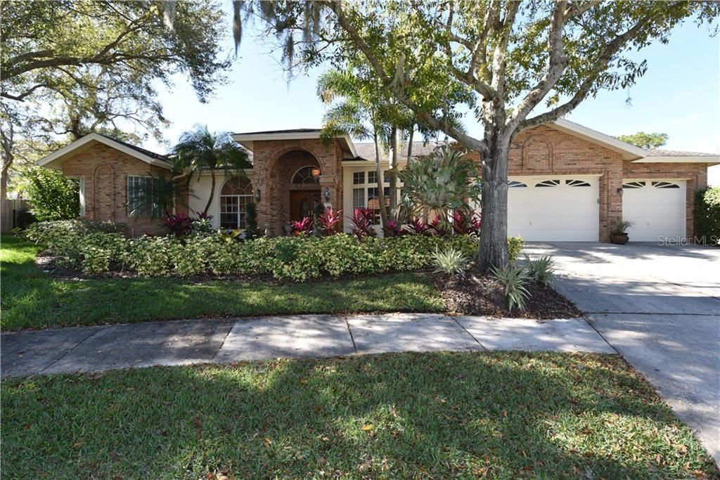 Front exterior with arched entry way and 3 car garage