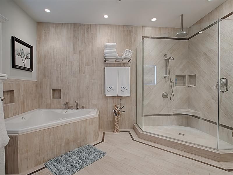 What an incredible Master Bathroom! Note the frameless glass shower walls and door, raindrop shower head, and additional hand held shower head. There is also a Jacuzzi tub for unwinding after a full day of Villages lifestyle!