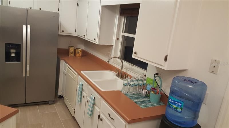 Deep double sink overlooks the patio and back yard. Dishwasher, disposal and oversized refrigerator/freezer included.