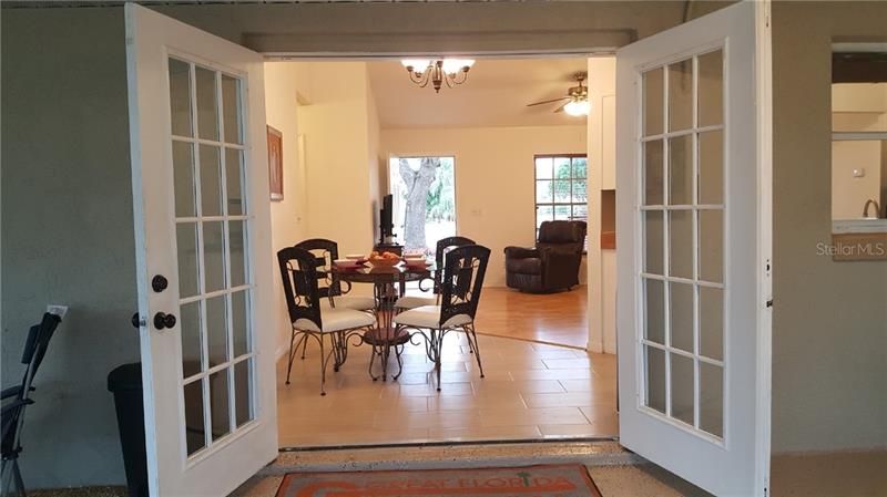 French doors open wide for free-flowing living inside and on the screened-in patio!