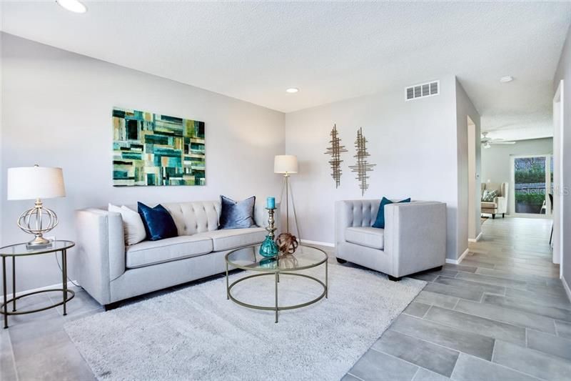 Spacious Living Room welcomes you at entry...new recessed lighting and porcelain floors