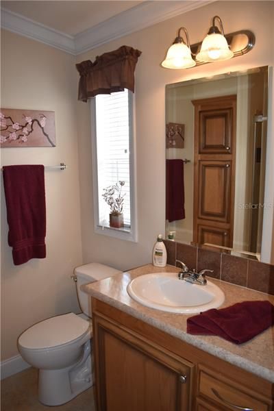 Master bathroom w/ceramic tile floor, linen closet, crown molding and comfort height toilet and sink.
