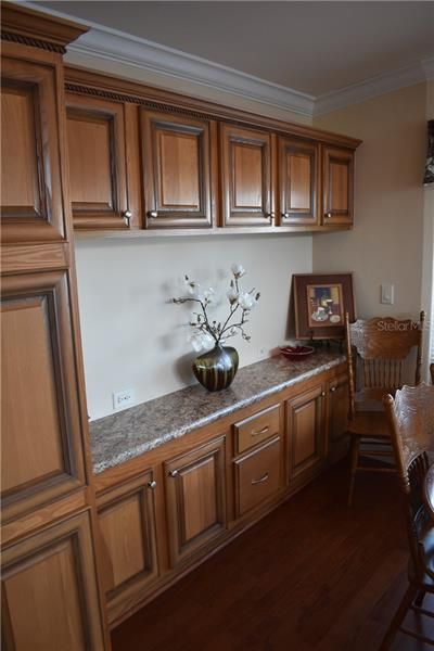 Serving counter in dining area with plenty of cabinets for storage.