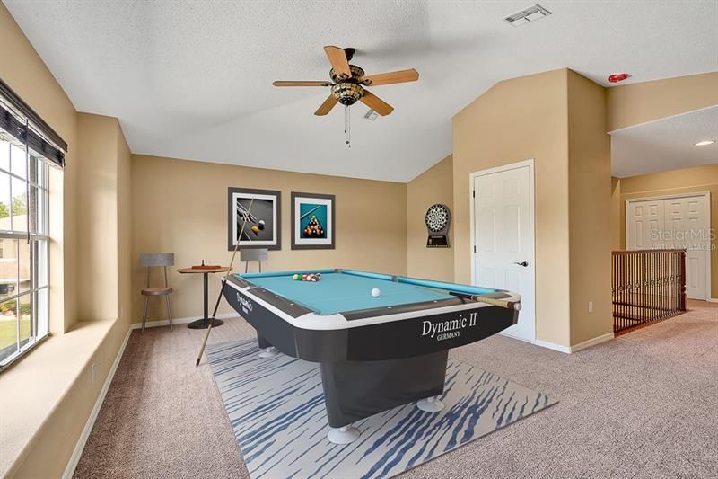 Virtually staged loft can be used as game room, office or massive bedroom.
