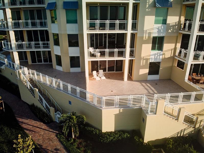 Where the 2 chairs are is the expansive patio terrace to included steps from you balcony to the path leading to the beach