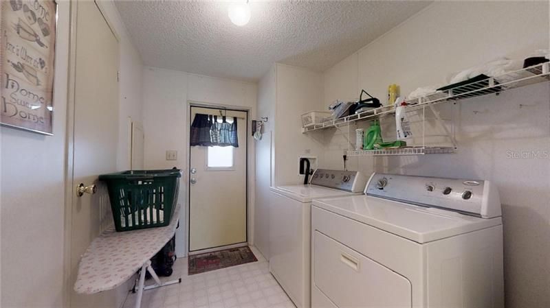 Indoor Utility Room with Washer and Dryer with easy access to Carport.
