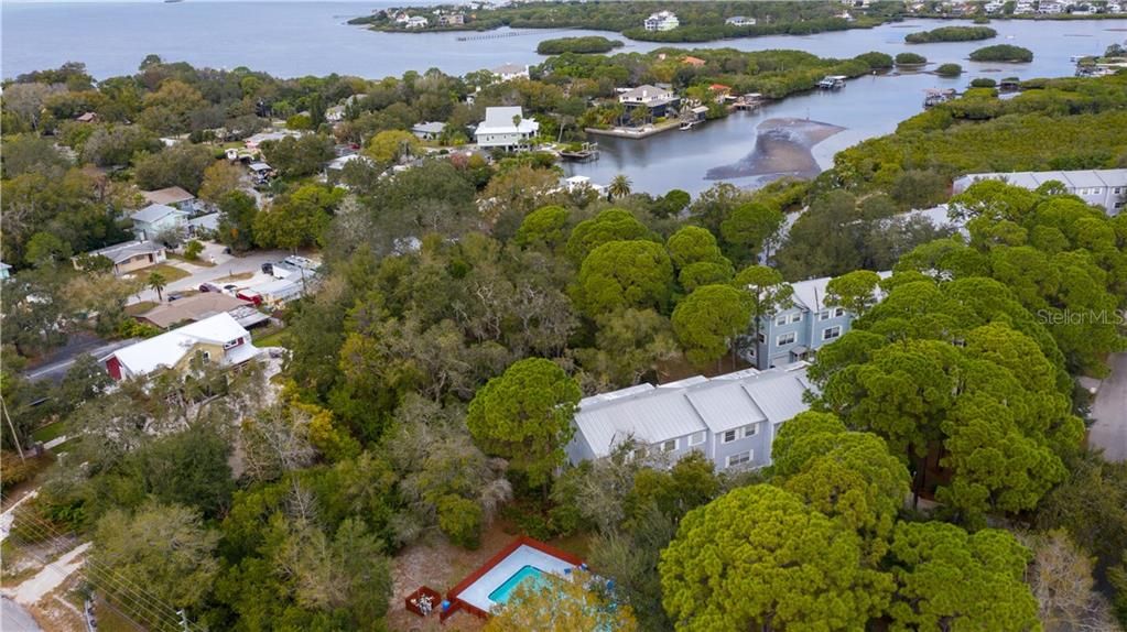 Beautiful Ozona community town home with both wooded and water views!