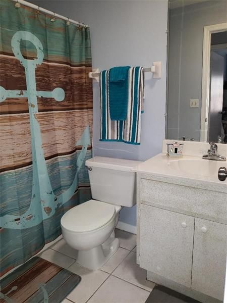 Beautifully redecorated hall bath with tub