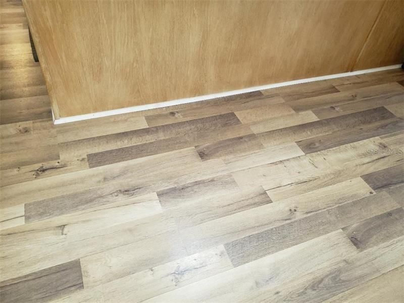 Beautiful laminate plank flooring that is throughout the home except the bathrooms.