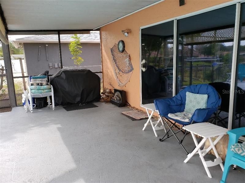 Enjoy the large covered lanai area when getting out of the pool and wanting some shade    This would be a great area for a table and chairs to sit and have dinner and enjoy the sun over the lake