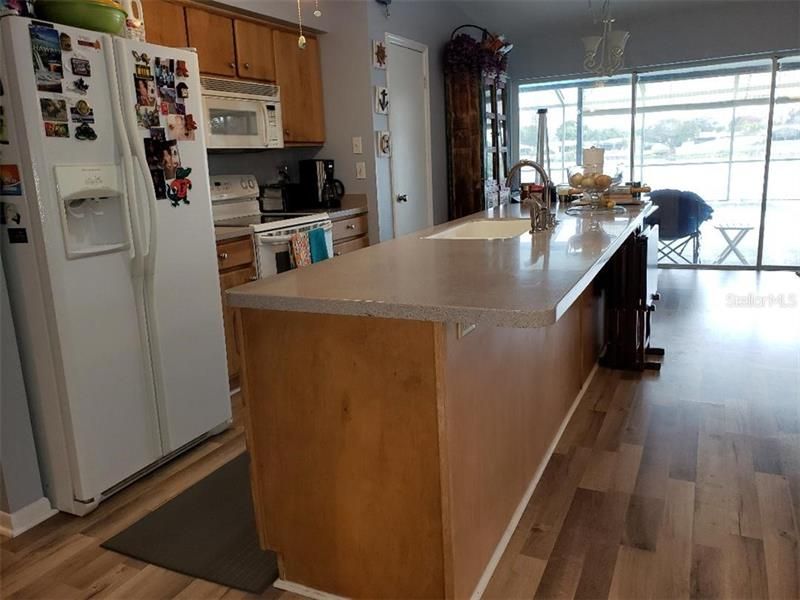 Enjoy the spacious kithcen work area with breakfast bar and center island sink.   Pantry closet in kitchen space and another one in the hall