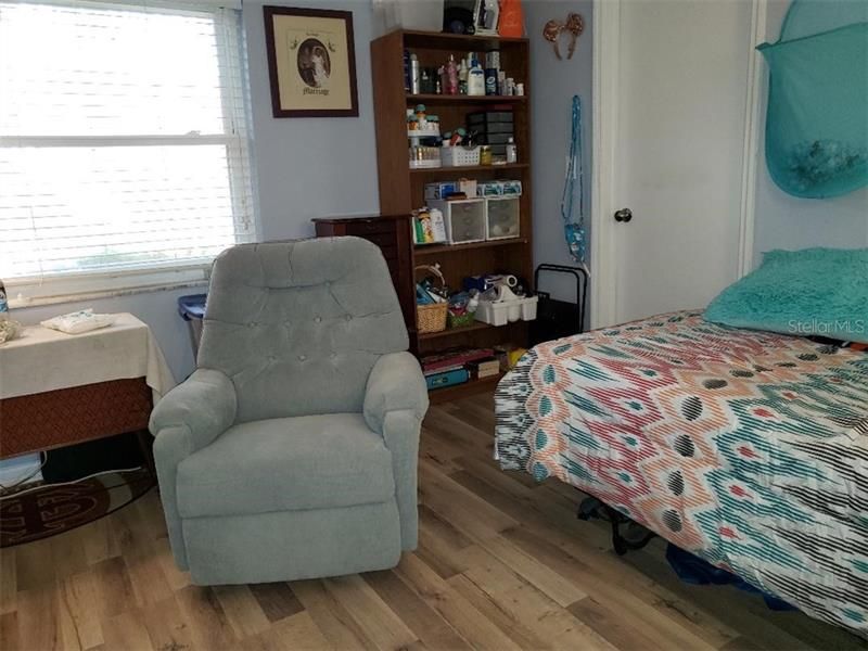 The other part of the second bedroom with the door to the walk in closet