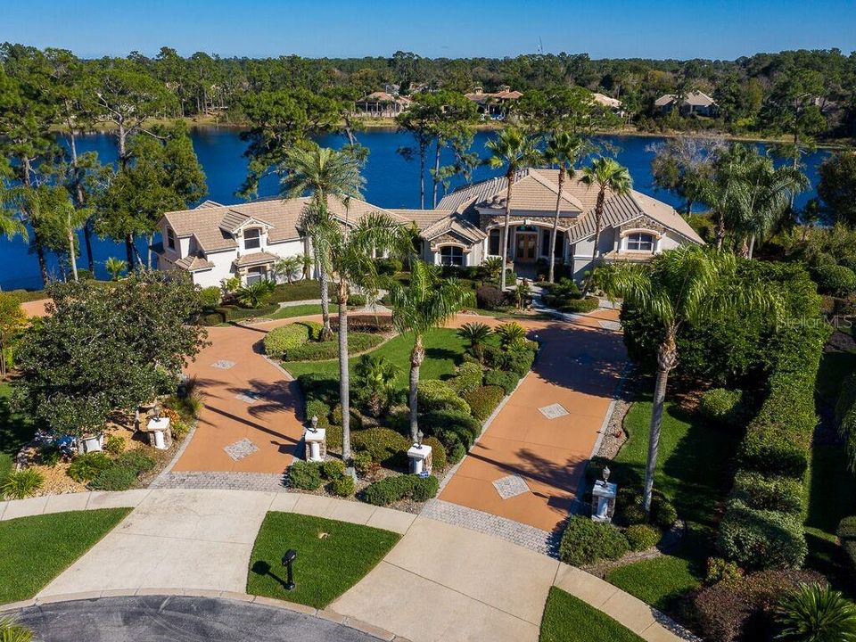 The Nest! Amazing home with lake frontage and golf course views.  Lot size of 3.65 acres is the largest in the community.