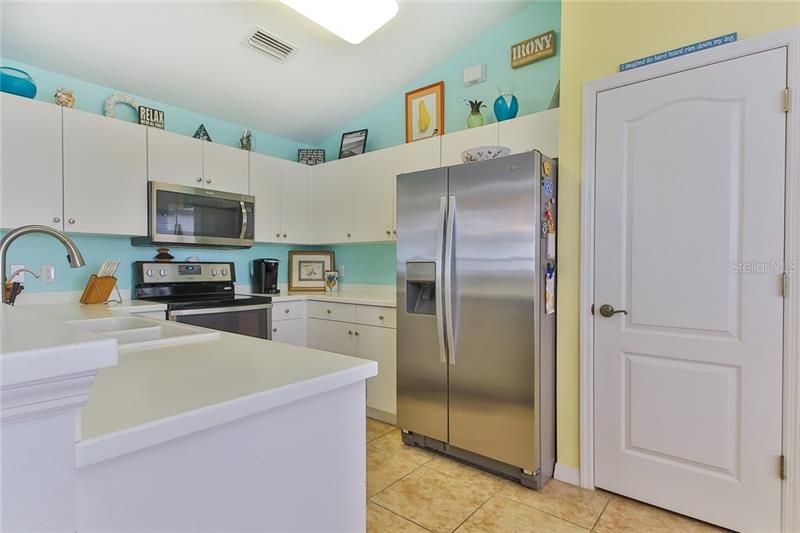 Appliances are 4 years old and stainless steel. Large pantry and vaulted ceilings.