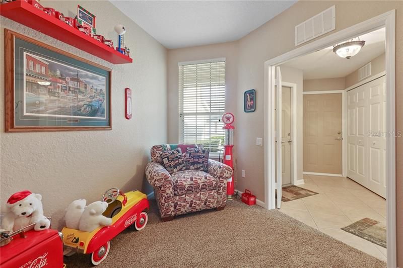 Den/playroom/man-cave. Closet doors to the right lead to laundry which includes newer washer and dryer.