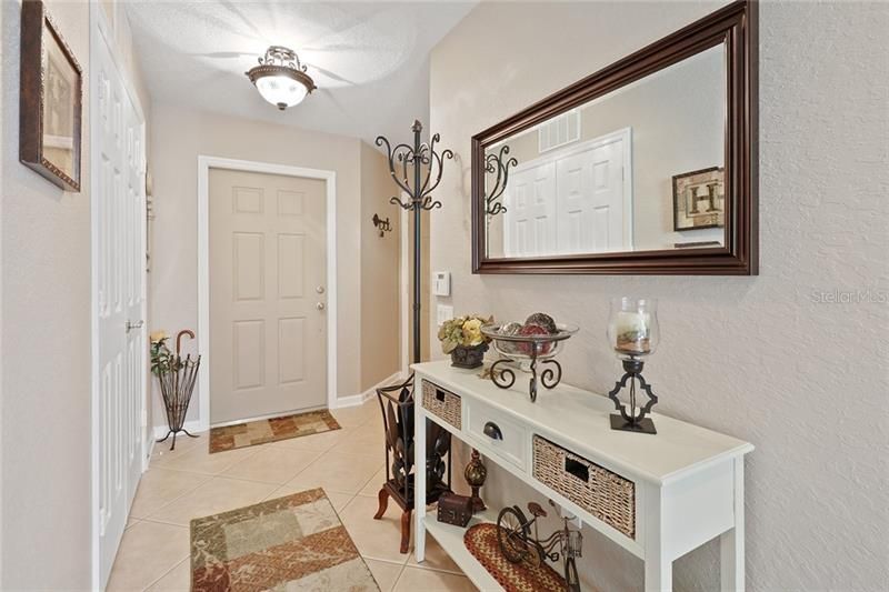 Foyer looking at the front entrance door. The doors on the left lead to Den/office/playroom. Currently being used as a den/man-cave.