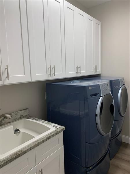 Laundry room all new cabinetry and sink. Lots of storage space. Washer/ dryer included.