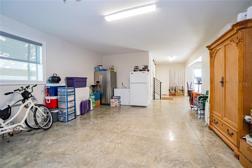 Beautiful polished garage floors. This is the right side. Not shown is the center area currently used as a fitness area and workshop and on the right side is additional garage space with the same polished floors that will accommodate 2 more vehicles.
