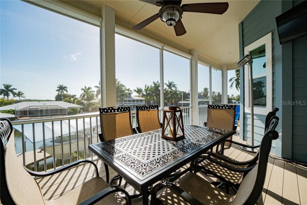 Expansive 2nd floor lanai/balcony overlooking the incredible saltwater pool/spa and canal.