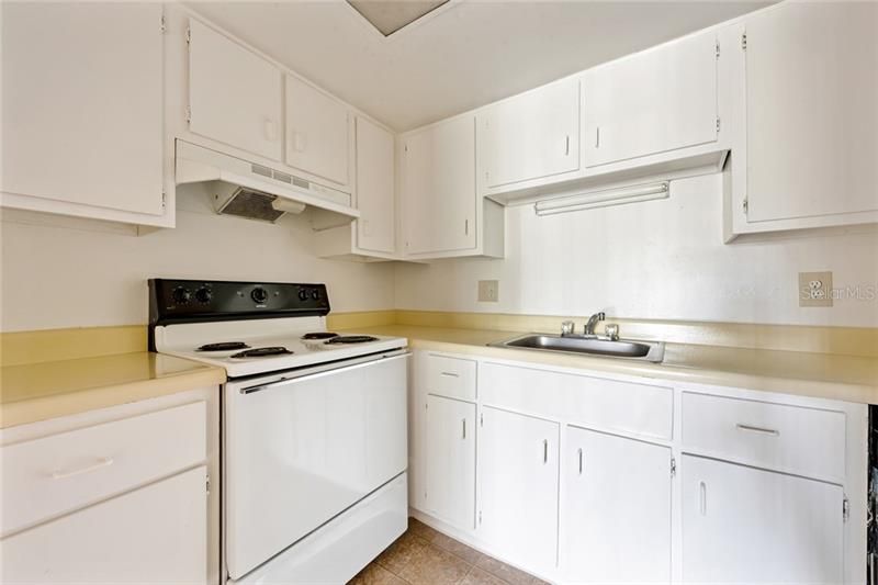 The kitchen features ample cabinet and counter space, solid surface counters and quality appliances.