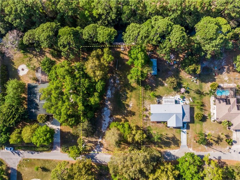 aerial view of 1/2 acre lot with 100 ft of frontage on Saltwater Canal leading to Lyon's Bay the Intracoastal waterway and the Gulf of Mexico.