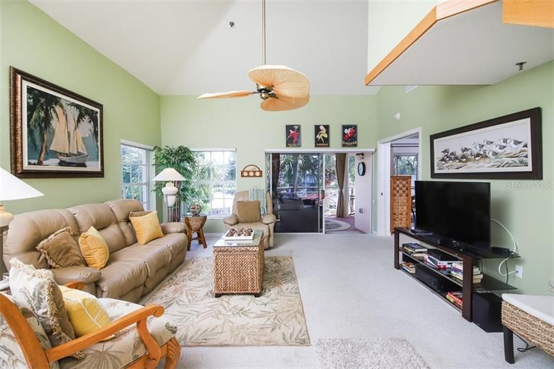 Living Room extends out to lanai overlooking pool, marina with some Intracoastal views